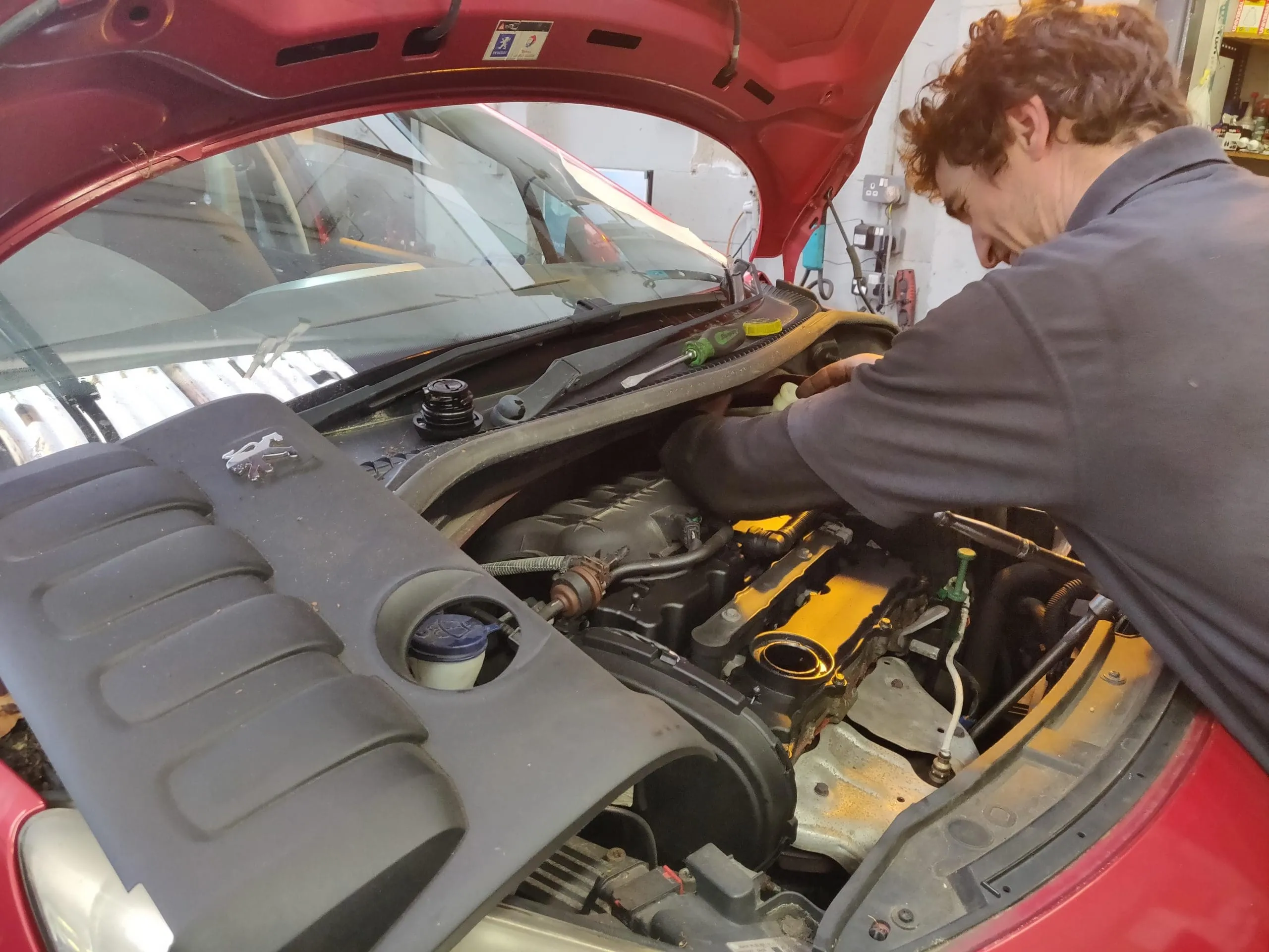 A technician working on an engine
